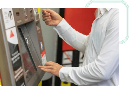 Person inserting a ticket on a vending machine